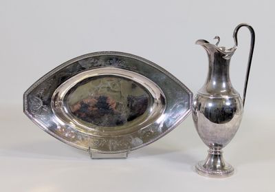 un plateau en argent et un pichet en argent posés sur une table