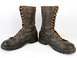pair of brown leather boots with laces on them on a white surface