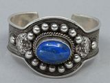 silver and lapis cuff bracelet with a blue stone in the center