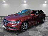 a red volkswagen passat is parked in a room with a checkered floor