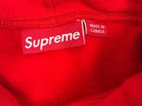 supreme brand label on a red jacket