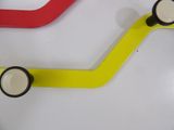 three different colored handles on a white table
