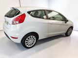 the rear end of a white ford fiesta parked in a white room