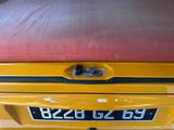 a yellow car with a red cushion on top of it