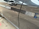 a close up of a car door handle with a sticker on it