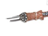 a fork that has a piece of meat on top of it