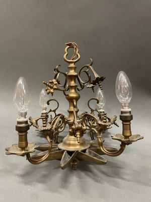 a close up of a chandelier with three lights on it