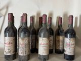 several bottles of wine are lined up on a table