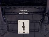 a close up of a black purse with a silver buckle