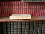 many books on a shelf in a book case