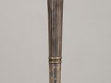 a silver candle holder sitting on a wooden table