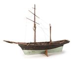 a small wooden boat that is on display on a white surface