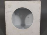 a white box with a hole in it on a table