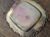 a small silver plate on a wooden table