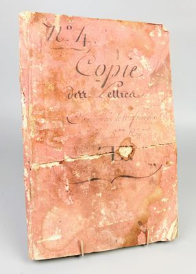 an old book with writing on it sitting on a table