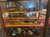 a display case with a lot of antique items on it