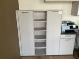 a white cabinet with a printer on top of it