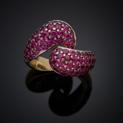 a close up view of a pink sapphire and diamond bypass ring