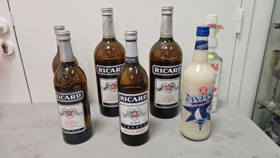 several bottles of beer are lined up on a counter