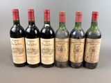 six bottles of wine lined up in a row on a table