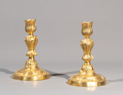 pair of antique brass candlesticks with flowers on each end