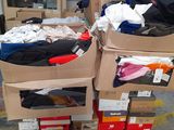 several boxes of clothing are stacked on top of each other in a warehouse