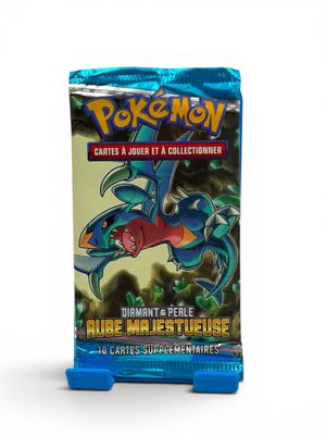 a close up of a box of pokemon cards on a white surface