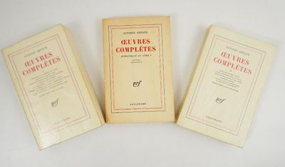 three books sitting on top of a white table next to each other