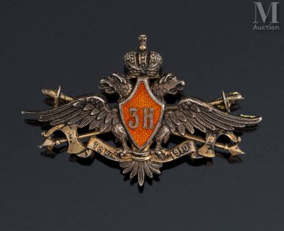 an orange and silver badge with a crown on top of a black background