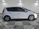 a picture of a white car parked in a garage