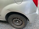 a car that has a flat tire on the side of the road