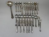 a lot of silver spoons and spoons on the table