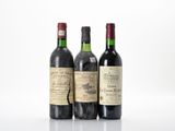 three bottles of wine sit side by side on a white surface