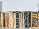 a lot of books that are on a shelf together