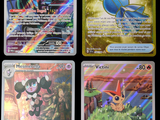 quatre cartes de pokémon différentes sont affichées sur une surface noire
