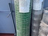 several rolls of wire mesh are stacked on a shelf in a store