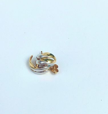 an image of a gold and silver ring on a white surface
