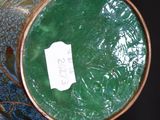 a vase with a green lid sitting on a table