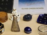 a table with a glass chess board and other items on it