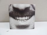a black and white photo of a man ' s mouth with a mustache