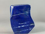 a close up of a blue stone on a white surface