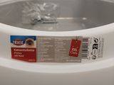 a white bowl with a label on it sitting on a table