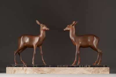 pair of bronze deer sculptures on marble base