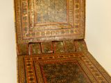 a small wooden chair with a wooden seat on a stand