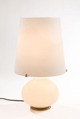 a lamp that is sitting on a table next to a lamp