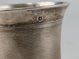 a silver cup that is sitting on a table