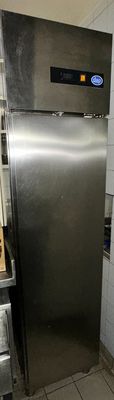 a stainless steel refrigerator in a small kitchen