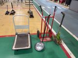 a hand truck and a dolly on the floor in a warehouse