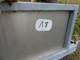 a man standing next to a metal box with a number on it