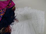a white dress and a pink scarf on a table